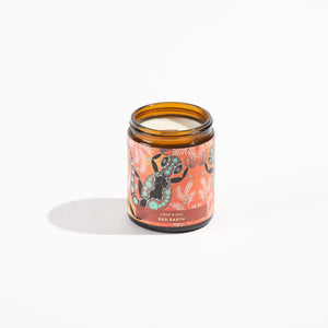 candle in brown glass jar with  aboriginal gecko design