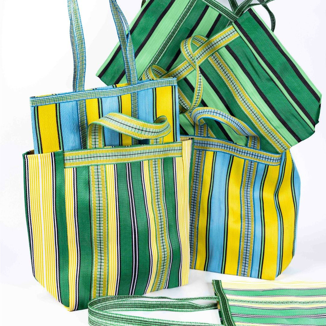 Image of multiple bags including yellow and aqua tote bag