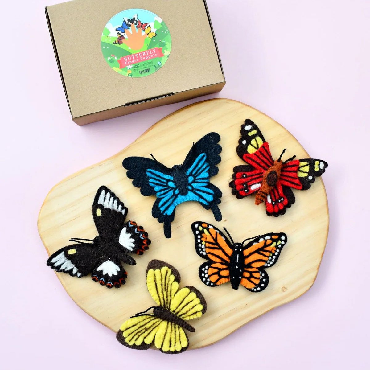 Top view image of butterfly finger puppets on wooden board