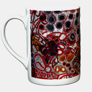 Side view image of Ceramic mug printed with 2010 artwork titled 'Yampil' by Tjawura Woods from the Spinifex Arts Project.