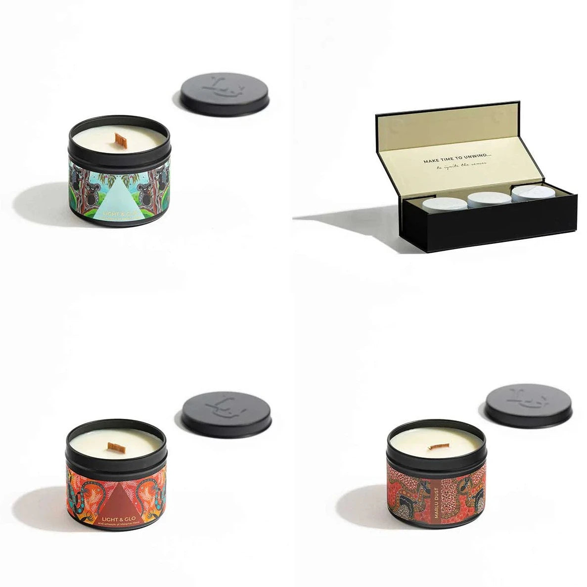 Candle trio out of gift box with their lids off.