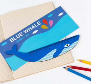 Image of blue whale wooden ruler with notebook and coloured pencils