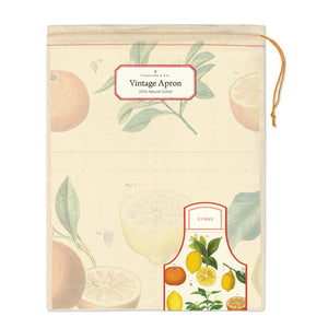 Vintage apron packaging with citrus fruit illustrations and label reading “Cavallini & Co. Vintage Apron 100% Natural Cotton.”