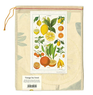 Vintage tea towel packaging with botanical citrus fruit illustrations including lemons, oranges, and limes.