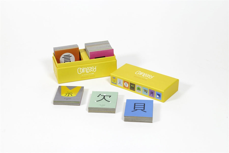 Image of Chineasy Memory Game showing open yellow box containing game cards and stacks of game cards on white background.