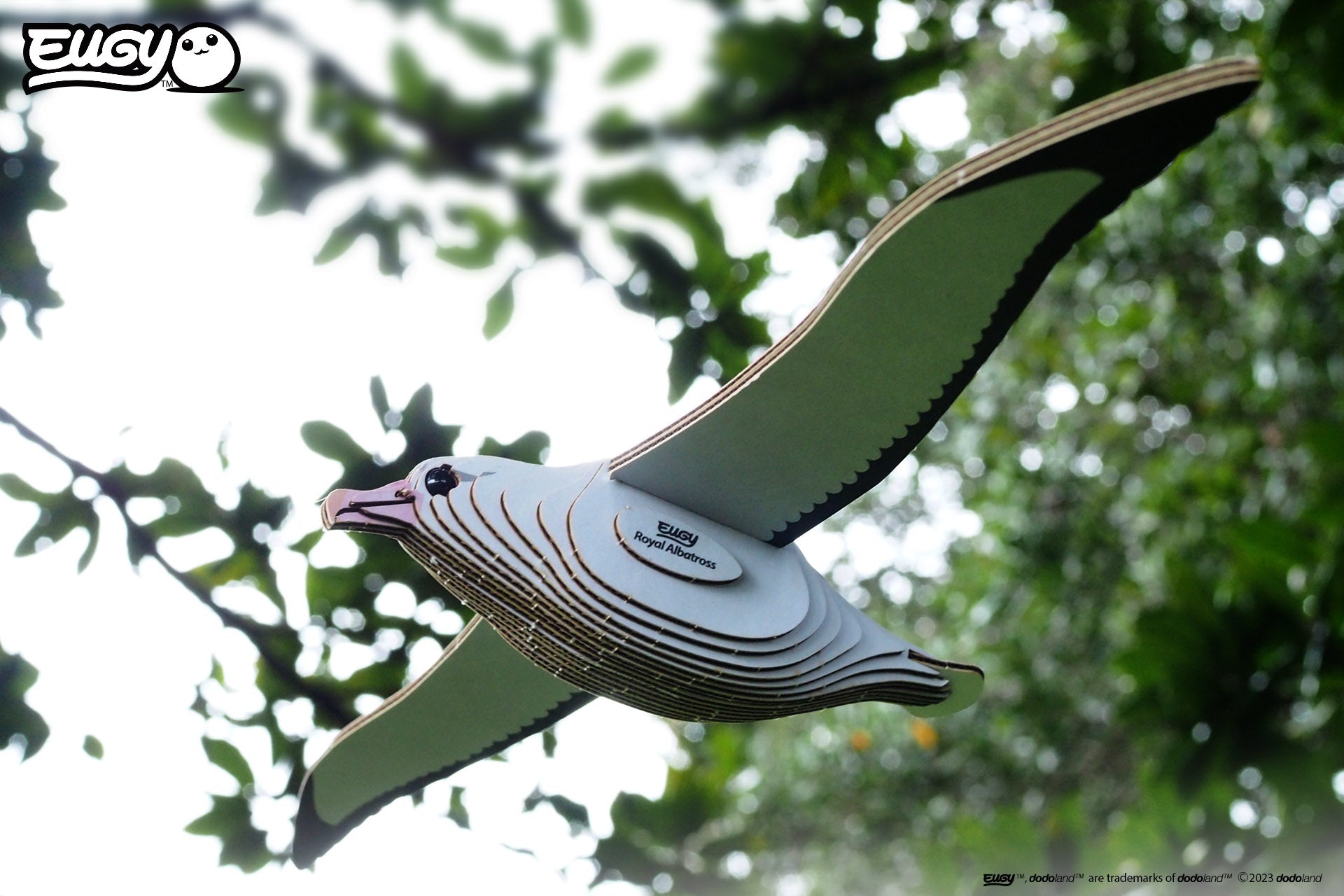 Side view image of EUGY Royal Albatross on a background sky and trees.