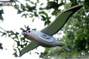 Side view image of EUGY Royal Albatross on a background sky and trees.
