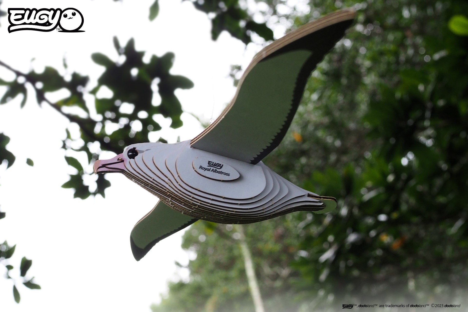 Side view image of EUGY Royal Albatross on a background sky and trees.