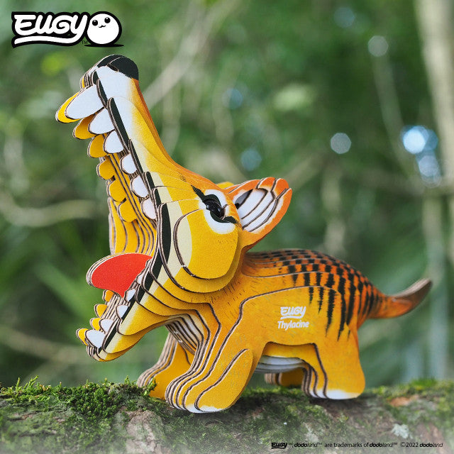 Side view image of EUGY Tasmanian Tiger on log with moss on green background.