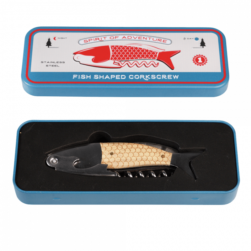 A blue rectangular tin box with a lid and base. The lid features a red fish illustration with the text "SPIRIT OF ADVENTURE" above and "FISH SHAPED CORKSCREW" below. "STAINLESS STEEL" is printed on the left side, with tree icons on both sides of the fish. Inside the box is a fish-shaped corkscrew with a black head and tail, beige scale-textured body, and a metal corkscrew extending from the bottom.
