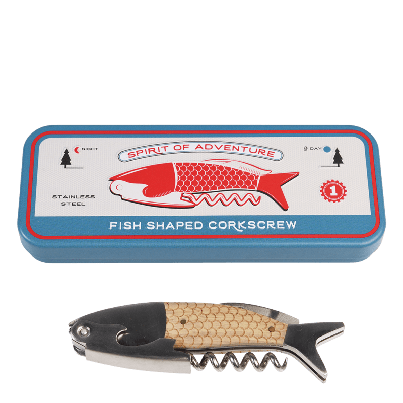 A blue rectangular tin box featuring a red fish illustration and the words "SPIRIT OF ADVENTURE" on the lid. The tin includes text such as "STAINLESS STEEL" and "FISH SHAPED CORKSCREW," along with day and night icons. Below the tin is a fish-shaped corkscrew with a metallic body, beige scale-textured handle, and a spiral corkscrew extending from the bottom.
