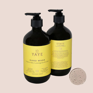Image of front and back of Yaye hand wash with yellow label on light pink background
