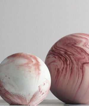 Two marbled ceramic balls on a light gray background
