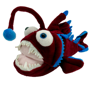 Side view image of Angler Fish plush toy on white background.