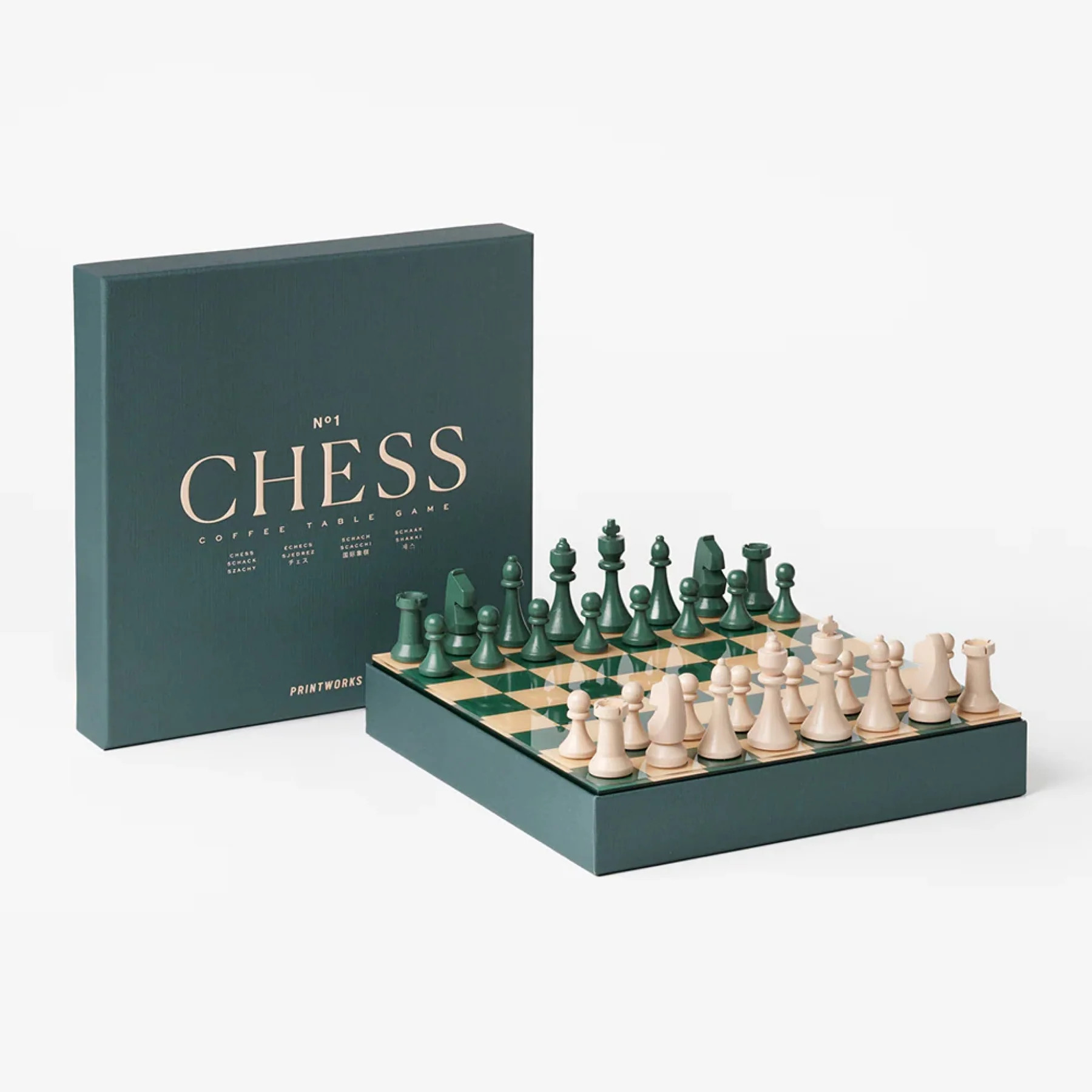 Chess set with green and white pieces and a matching box on a white background