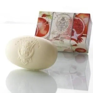 Oval La Florentina soap with embossed logo, placed in front of box with pomegranate images and brand name.