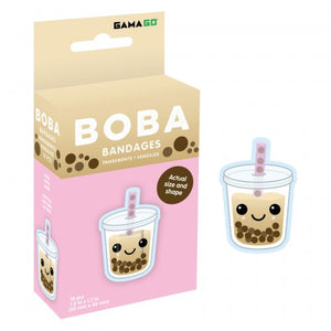 Image of a box of Gama Go Boba Bandages featuring a cute cartoon boba tea cup with a smiling face, pink straw, and brown tapioca pearls. The packaging is beige and pink with the text 'BOBA BANDAGES' and shows the actual size and shape of the bandages, with one bandage displayed to the right of the box.