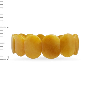 Side view image of yellow Jade oval shaped beaded bracelet on white background.