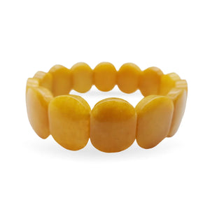 Image of yellow Jade oval shaped beaded bracelet on white background.