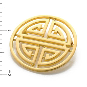 Image of Shou symbol brooch, round gold cut out symbol on white background.