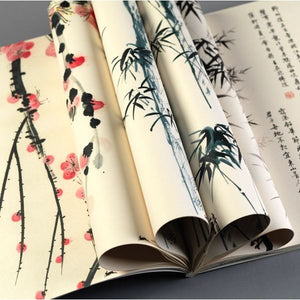 Image of Gift and Creative Papers Book – Chinese Art Edition, showing open book with Chinese artworks and curled pages.