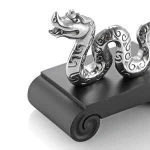 Close up image of Chinese Zodiac Snake Figurine by Royal Selangor, showing silver snake figurine on black stand on white background.