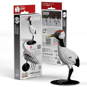 Side view image of EUGY Crane showing 3D carboard model of a red-crowned crane with white body, black neck and legs, and a red patch on the head and packaging on white background.