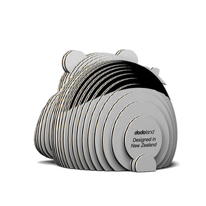 Rear view image of black and white 3D Eugy panda model made of layered, recyclable cardboard, sitting upright against a white background.