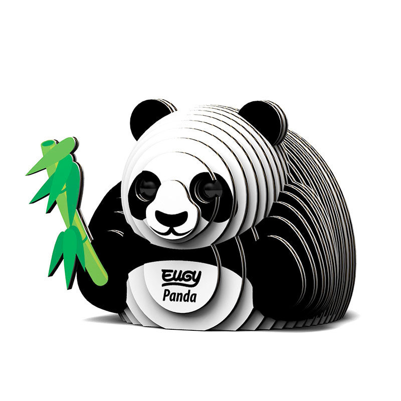 Image of black and white 3D Eugy panda model made of layered, recyclable cardboard, sitting upright and holding a green stick of bamboo against a white background.