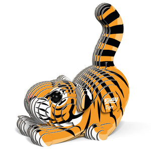 Side to front view image of Eugy Tiger, showing tiger model made form layers of cardboard in orange, black and white. Models paws are stretched out in front with bottom in the air and tail sticking up. White background.