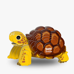 Image of Eugy Tortoise, showing tortoise with yellow legs and head and brown shell made from layers of cardboard, on white background.