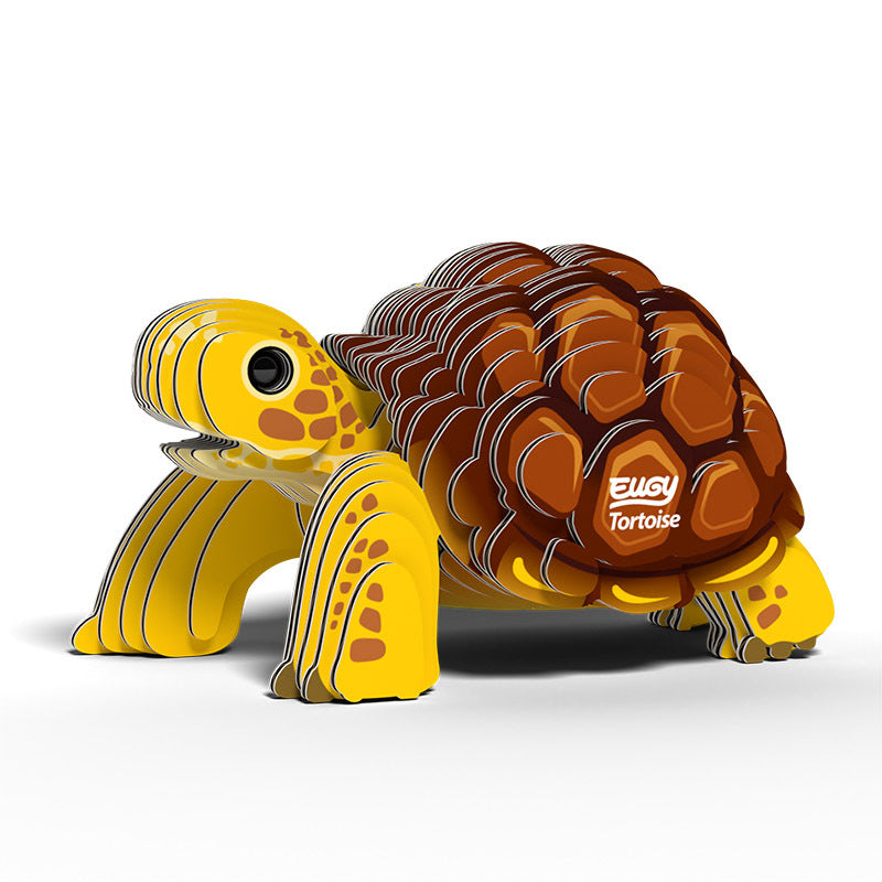 Side to front view image of Eugy Tortoise, showing tortoise with yellow legs and head and brown shell made from layers of cardboard, on white background.