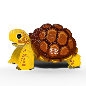 Side view image of Eugy Tortoise, showing tortoise with yellow legs and head and brown shell made from layers of cardboard, on white background.