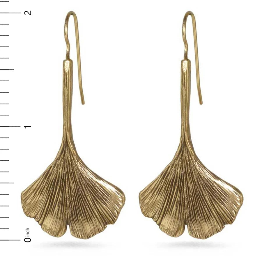Image of ginkgo leaf shaped drop earrings in gold finish on white background.
