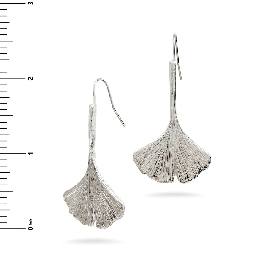Image of ginkgo leaf shaped silver drop earrings on white background.