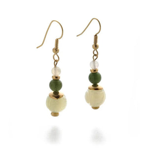 Image of pair of gold hanging earrings with three jade beads on white background. 