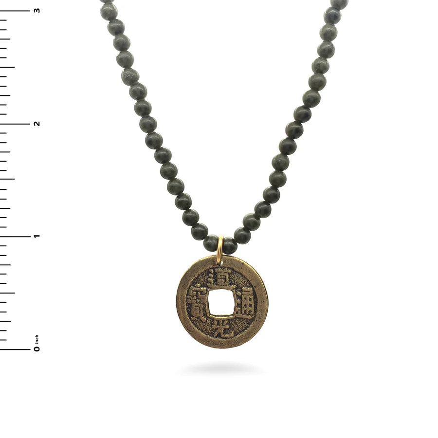 Image of Chinese coin pendant on dark green jade bead necklace on white background.