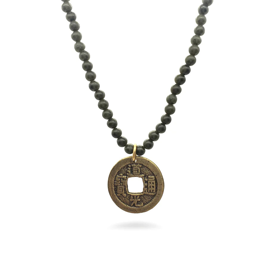 Image of Chinese coin pendant on dark green jade bead necklace on white background.