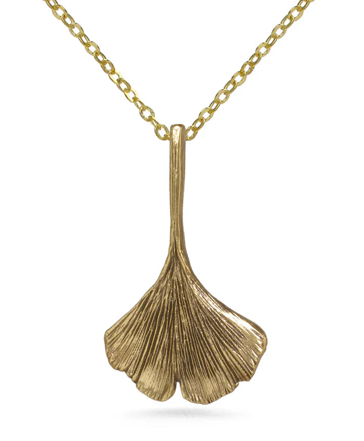 Image of ginko leaf shaped pendant in antique gold on gold chain, on white background. 
