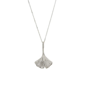 Image of ginko leaf shaped silver pendant on silver chain on white background.