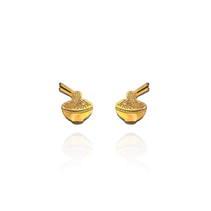 Pair of gold-plated stud earrings shaped like noodle bowls with chopsticks. The earrings feature intricate etched detailing representing noodles and utensils, with a reflective surface and a minimalist, playful design.