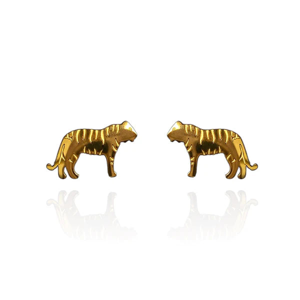 Image of a pair of gold-tone stud earrings in the shape of tigers, featuring engraved stripe details and a sleek silhouette. Displayed on a white background with a subtle mirrored reflection beneath each earring.