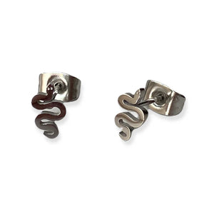 Image of a pair of silver-tone stud earrings shaped like stylized serpents with coiled bodies and small round eyes, displayed on a white background with a subtle mirrored reflection.