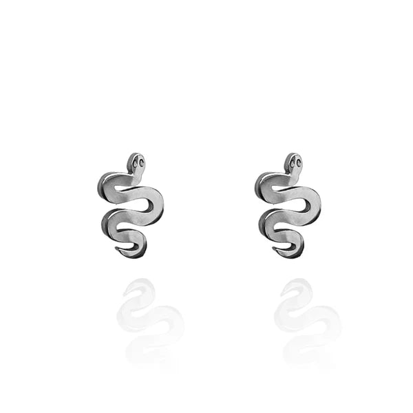 Image of a pair of silver tone-tone stud earrings shaped like stylized serpents with coiled bodies and small round eyes, displayed on a white background with a subtle mirrored reflection.