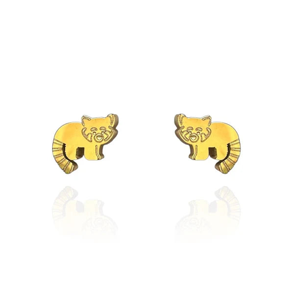 Image of a pair of gold-tone stud earrings shaped like red pandas, featuring engraved facial details and striped tails. Displayed on a white background with a subtle mirrored reflection beneath each earring.
