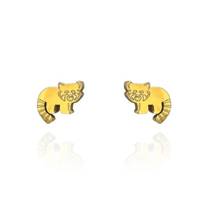 Image of a pair of gold-tone stud earrings shaped like red pandas, featuring engraved facial details and striped tails. Displayed on a white background with a subtle mirrored reflection beneath each earring.