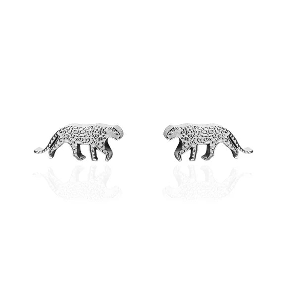 Image of a pair of gold-tone stud earrings shaped like walking snow leopards, featuring engraved spots and curved tails, displayed on a white background with a subtle reflection.