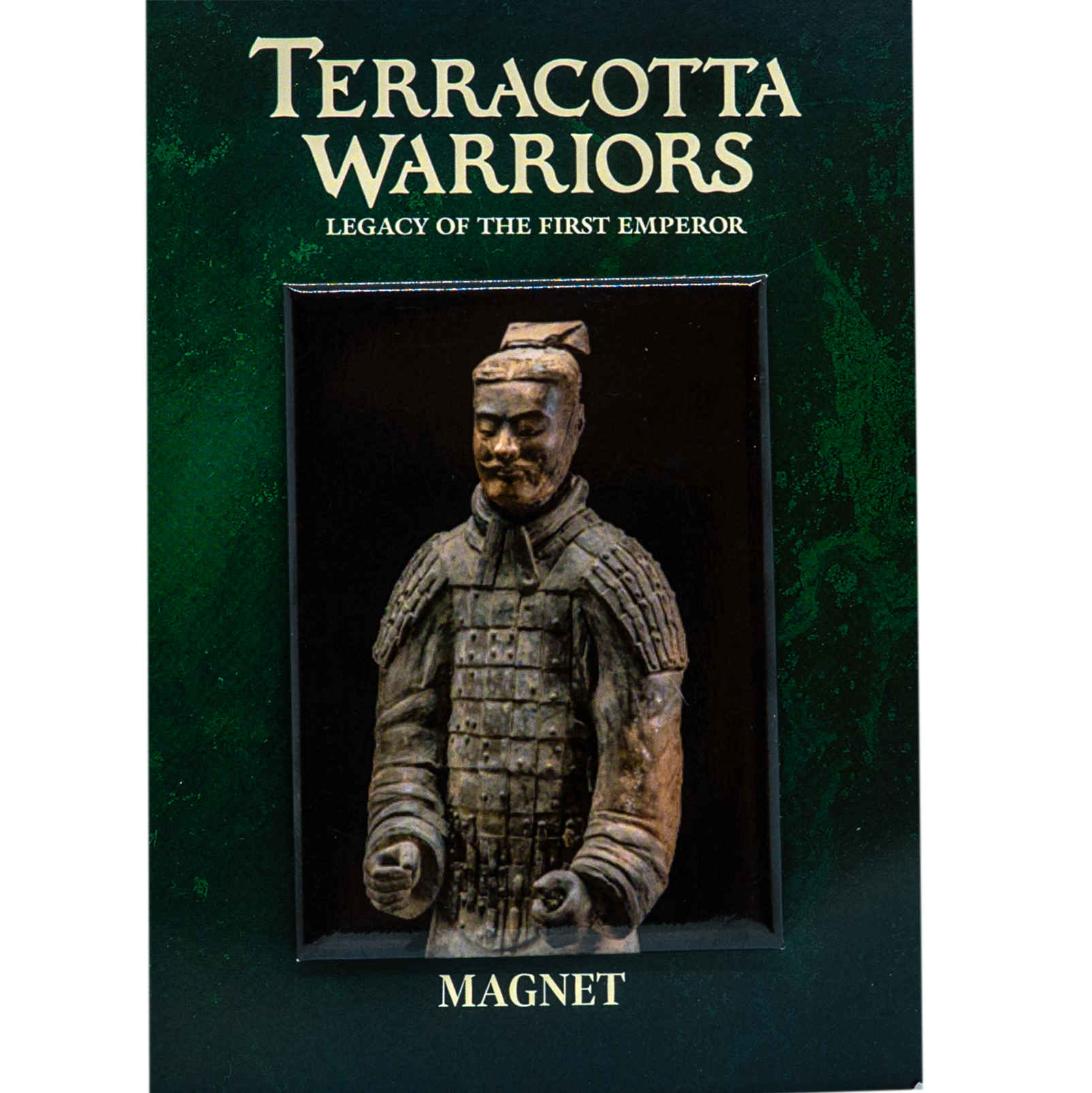 A souvenir magnet featuring a 3D miniature replica of a Terracotta Warrior, mounted on a dark green card that reads "TERRACOTTA WARRIORS – Legacy of the First Emperor" at the top and "MAGNET" at the bottom. The warrior is depicted in detailed armor with a topknot hairstyle, resembling the famous ancient Chinese Terracotta Army statues.
