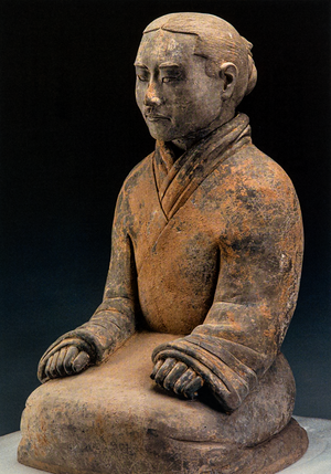 Postcard featuring a seated terracotta warrior statue in traditional ancient Chinese attire with detailed folds, set against a dark background.