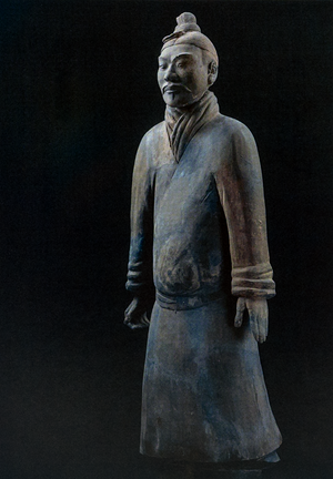 Postcard featuring a standing terracotta warrior statue in traditional Chinese armor with detailed folds; set against a dark background.